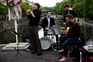 Petra Vlková Quartet performing live on the outdoor stage at Jazz Dock Prague, with the Vltava River in the background.