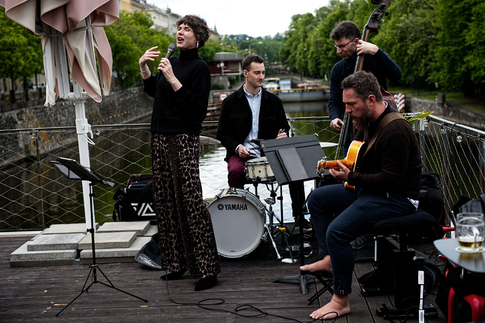 Petra Vlková Quartet performing live on the outdoor stage at Jazz Dock Prague, with the Vltava River in the background.